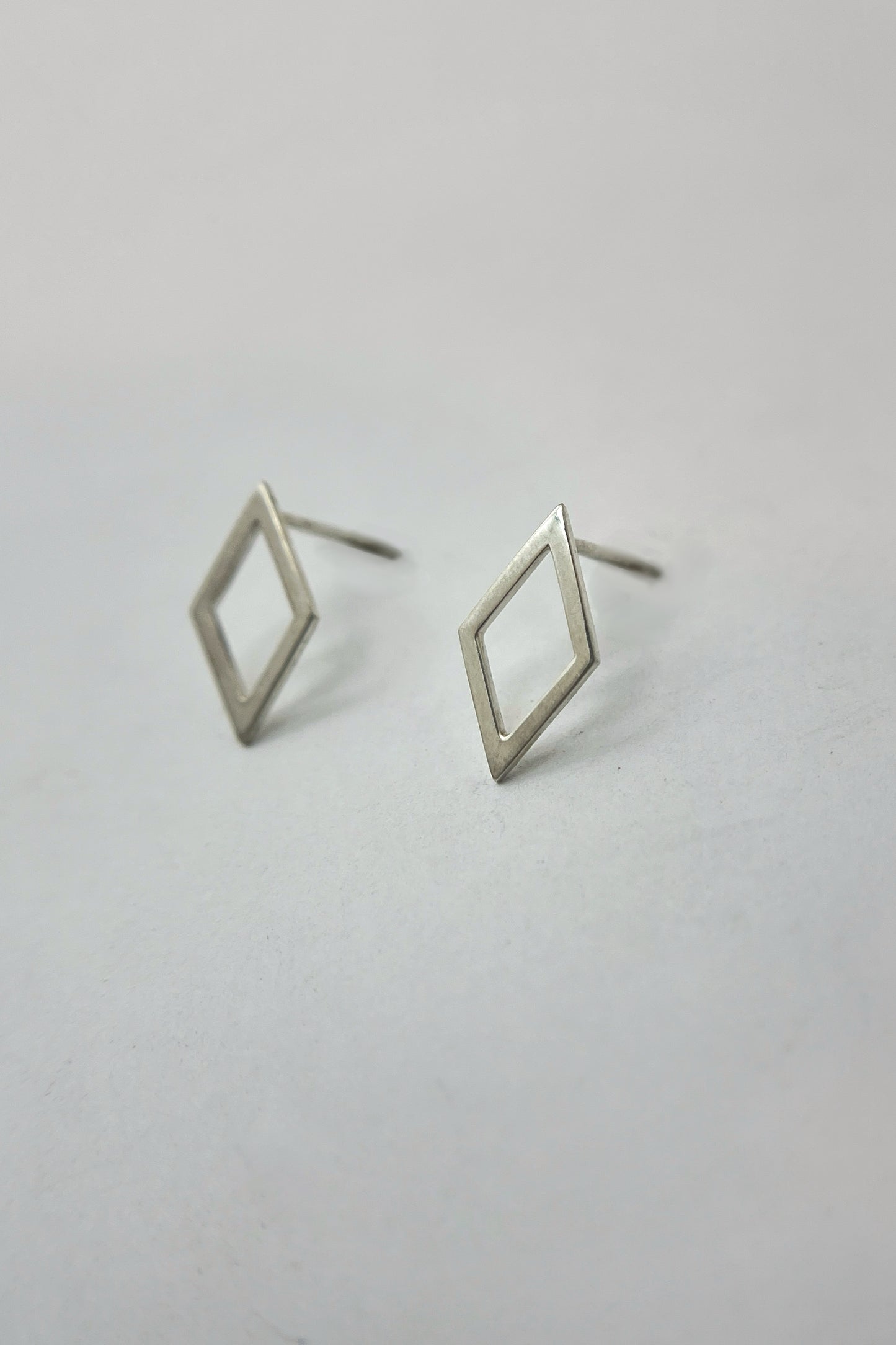 open rhombus stud earrings